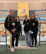 Grandmaster Doug Cook, left, with instructors Michele Radakovits, Brain Parkinson, and Jean Bailly-Orlovsky, inside the General Assembly at United Nations headquarters in New York City.