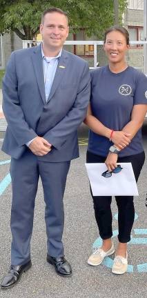 New Hampton. More than 100 men and women from 30 fire departments graduate from county firefighting training program County Executive Steven M. Neuhaus congratulates firefighter graduate Lina Yang of the Cornwall-on-Hudson Fire Department. Photo provided by Orange County.