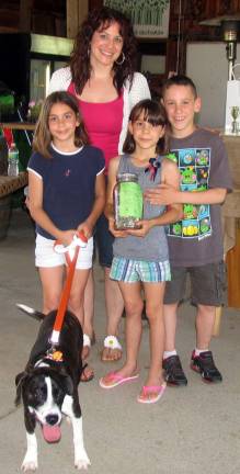 Even after nine years, someone’s still letting the dogs out Photos byRoger Gavan Jeanne Nostrame introduced triplets Aeva, Elle and Reece Manara, and their dog Bella, winner of the best tail-wagger contest. The children sold lemonade and raised $76, saved in a jar, for the Warwick Valley Humane Society.