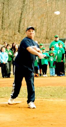 Play ball Little League President Chris Cassf kicked off the 2014 Greenwood Lake Little League season by tossing the first pitch to his son Christian, a catcher for the Lion's team.