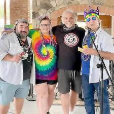 Celebrating the Mardi Gras for a Cause Festival from left are Tony Vee, Uncle Shoehorn lead guitarist and vocals; Jennifer Price, executive director Backpack Snack Attack; Don Oriolo, owner Blue Arrow Farms; and Johnny D. Desibia, Mardi Gras Event founder and 2021 chairman. Provided photo.