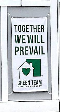 Encouraging sign posted outside the Green Team real estate office in the Village of Warwick. Photo by Roger Gavan.