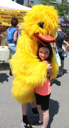 $5 tickets. More than 4,000 rubber ducks. More than $20,000 raised. Camryn Tual, 7, enjoys a big hug from the Winslow Duck, aka her brother Zachary Tual, 13.