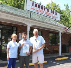 Larry's Deli has always been a big supporter Backpack Snack Attack President Shirley Puett and volunteer Len Singer pose with. Larry's Deli owner Ronak Patel (center).