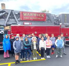 Park Avenue students pose for a photo by the Warwick FD Tower Ladder during Fire Prevention classes.