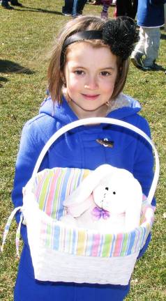 In search of the golden eggs Samantha Beady, 7, brought along a friend in her basket to help with a successful egg hunt.