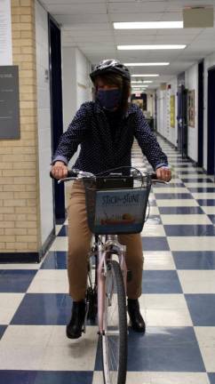 A week ago Wednesday, Golden Hill Elementary School Principal Debbi Lisack secured her bicycle helmet and hopped on her bike, making her first trip around Golden Hill this school year to bring a story by one of her favorite authors, Beth Ferry, to each classroom. Photos provided by Florida School District.