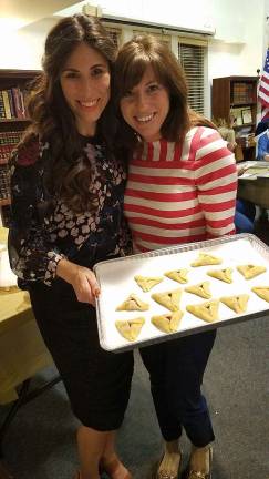 Chabad’s Purim celebration taking us back to the ‘Shetl’ on March 12 Chana Burston of Chabad of Orange County leads a Hamantaschen Baking workshop and is pictured (left) with Heather Greenberg of Monroe, holding her oven-ready cookies.