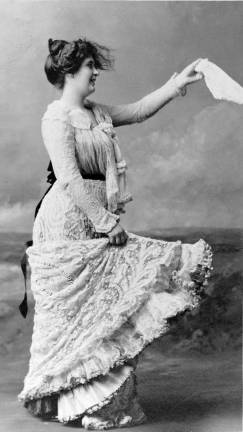 Woman in lace dressing waving a hankerchief, c. 1900