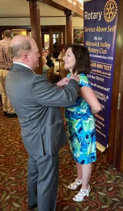 Tina Buck heads Warwick Rotarians Warwick Valley Rotary Club President Tina Buck receives her presidential pin from outgoing president Ed Wiley during the club’s 44th annual installation ceremony June 26 at the Chateau Hathorn.