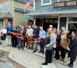 On Wednesday, Oct. 27, state, county and local officials along with members of the Orange County, Warwick Valley and Florida Chambers of Commerce joined owners Tony Sylaj and Marc Lombardo, their staff, relatives and friends for the grand opening of Barrel 28. Owner Robert Knebel was away and not available for the photo. Cutting the ribbon were from left Harold Knebel (son of owner Robert Knebel), Tony Sylaj and Marc Lombardo. Photo by Roger Gavan.