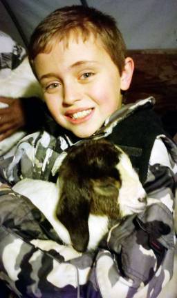 Orange County 4-H offers Borrow A Goat program for young people Garrett Boelens enjoys a cuddly goat kids which is part of þÄúBorrow A Goat" program sponsored by Cornell Cooperative Extension Orange County.