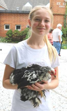 Parish holds Blessing of Animals in honor of St. Francis of Assisi Photos by Roger Gavan Grace Morgiewiz, 12, brought her pet chicken, "Salt."