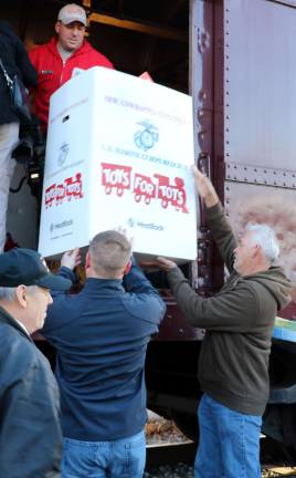 Volunteers helped load the train with gifts that had been collected locally during the holiday season.