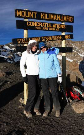 Exhausted yet excited, Yvonne Vandenberg of the Village of Florida and her aunt, Yvonne Reneman, are all smiles after reaching the summit of Mt. Kilimanjaro.