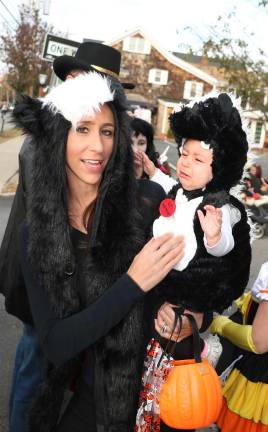 Annual Lions Club and Village of Warwick Halloween Parade draws 1,200 witches, goblins and other assorted characters Diana Woglom and her baby skunk, Madelyn, who doesn't seem happy about dressing up for Halloween.