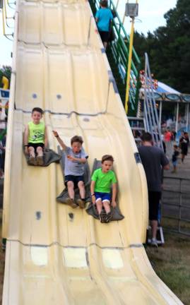 Let summer begin Photos by Roger Gavan One of the most popular rides for children is the huge slide.