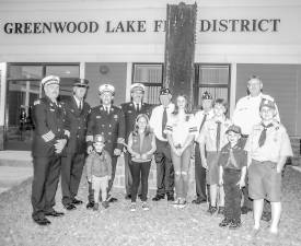 Members of the Greenwood Lake Fire Department, Ambulance Corps, Police, Boy Scouts, Girl Scouts, Ladies Auxiliary and residents of this close-knit community gathered at the fire house to mark the 20th anniversary of the Sept. 11 terrorists attack against the United States last Saturday. The late state Sen. Thomas P. Morahan arranged for the village to receive an I-beam from the Trade Towers. It has been the focal point of the community ever since. Photo by Ed Bailey.