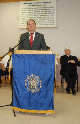 Greenwood Lake remembers and honors Greenwood Lake Mayor Jesse Dwyer speaks during the indoor ceremony. The Rev. Robert Sweeney, right, provided prayer for the service.