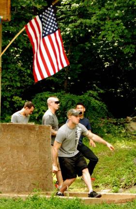 GWL American Legion host barbecue for troops Photo by Ed Bailey U.S. Sgt. Matthew Baker of the 10th Mountain Division pitches horshoes at the barbecue put on for the troops by the Greenwood Lake American Legion.