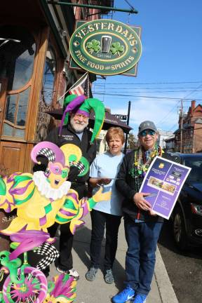 Sixth annual Mardi Gras for a Cause raises almost $14,000 Photo by Roger GavanYesterdays owner John Christison was an enthusiastic supporter of Mardi Gras for a Cause and was one of the participating establishmentproviding musical entertainment for the evening. Pictured from left to right are: Yesterdays owner John Christison, Shirley Puett, the director of BackPack Attack, and event organizer John Desibia.