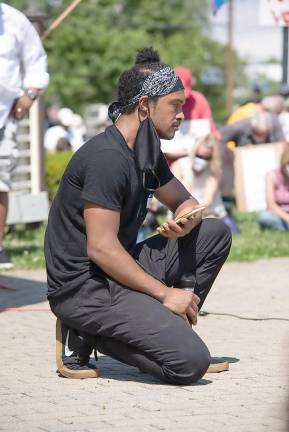 Sam Madden leads a moment of silence on Saturday, June 6, at the Warwick Against Racism Protest lasting eight minutes and 46 seconds - the length of time that Officer Derek Chauvin held his knee on the neck of Minneapolis resident George Floyd during an arrest which led to his death. Photo by Tom Kates.