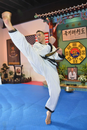 Grandmaster Brad Shipp performs a high twist kick.
