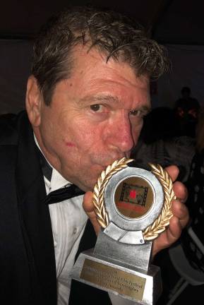 And the winner is…. Photo provided Greenwood Lake resident John Bernieri kisses his Hoboken International Film Festival Award for ‘best unproduced screenplay’ for ‘Rose’s House’ during the festival’s Gala Awards Ceremony on May 24.
