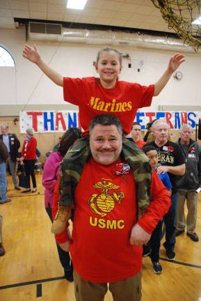 Veterans Breakfast at Park Ave Marine Corps veteran Jeff Ligg celebrates with young Elias during the Veterans Day Breakfast at Park Avenue Elementary.