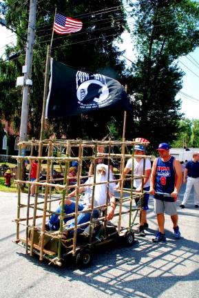 Fun on the Fourth Until they all come home: Pictured is the American Legion Post 1443 POW/MIA cage at the Greenwood Lake July 4th parade, remembering the 83,432 Americans still missing in action.