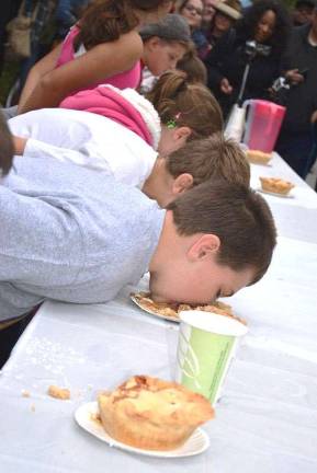 Applefest 2016 draws large crowds despite light rain and cooler weather Warwick resident DJ Gardner, 10, gives it his pie-eating all during the children's round of the popular contest. sponsored by Nobel Pies.