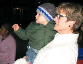 Chief Schweikart led the crowd with the official countdown and tree lighting. Jacob Bobrzynski, 15 months, has the most comfortable seat in the audience in the arms of his grandmother, Donna Cassanite.