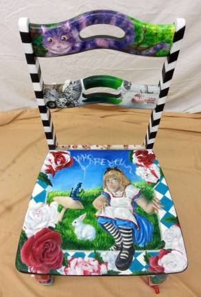 There is a chair for everyone One of the chairs to be auctioned at the Warwick Valley Art show is this one, depicting a scene from Lewis Carroll's "Alice in Wonderland," by Cassie Nunez.