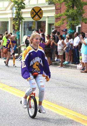 Crowds enjoy Homecoming Day Parade on Main Street Ava Levitsky, 13, demonstrates a special skill on her unicycle.