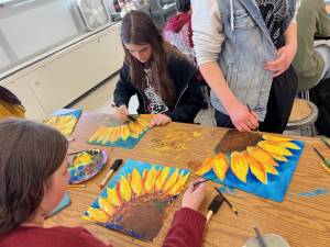WVHS art students learn how to paint sunflowers in preparation for the event.