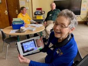Lions Club member Esther Zaccone with an eye scanner used for vision screenings.