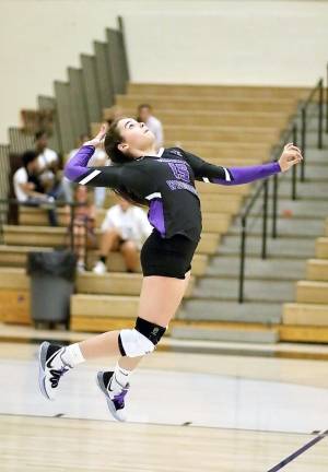 Monroe-Woodbury Varsity Volleyball player Jordan Ader unleashes one of her ferocious serves during a non-league match a year ago against the Wallkill High School Panthers. The fall volleyball season, like the seasons for football and competitive cheer leading, has been postponed until March 1, 2021, to address membership concerns associated with high-risk fall sports. File photo by William Dimmit.