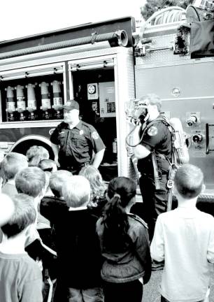 Kids, firefighters and safety Photo by Ed Bailey Lt. Joe Russo demonstrates breathing apparatus.