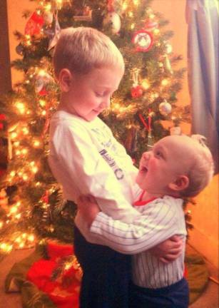 Only 2 days left to vote! Submitted by: Toni Vogel of Warwick, N.Y. "A precious Christmas moment between brothers (Justin Vogel, age 4 and Joshua Vogel age 1). We just finished decorating our Christmas tree and I was taking pictures of the boys. After much frustration because they wouldn't stay still for a picture, I said "ok, we are all done". Then,out of the blue, my younger son went over to his big brother and hugged him. Luckily, my camera phone was still in hand to capture this moment! Its brotherly love at Christmas time!"