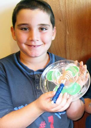 Chabad of Orange County announces High Holiday services and children’s programs Zachary Freedman, 8, of Warwick diplays the honey dish he created in Chabad Hebrew School as he studied the Rosh Hashanah tradition of dipping apples in honey. Eating apples dipped in honey is cutomary on Rosh Hashanah to symbolize the hope for a sweet year.