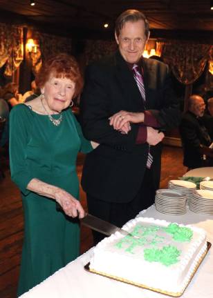 St. Stephen’s Educational Trust hosts 22nd annual cocktail party. Elaine Scharfenberger, 97, pictured with her son Dr. Dennis Scharfenberger, was invited to cut the traditional cake for all the guests.