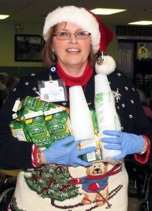 Schervier Pavilion hosts Christmas party Recreation aide Roselle Egan and other staff members were on hand to serve holiday treats to each resident.
