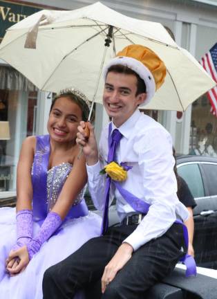 The Homecoming Day King Liam Fomin and Queen Destiny Reyes, displaying their sense of humor and Royal privilege for the unexpected rain