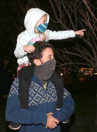 Carly Orthmann, 5, has the best seat in the house on the shoulders of her dad, Lee Orthmann.