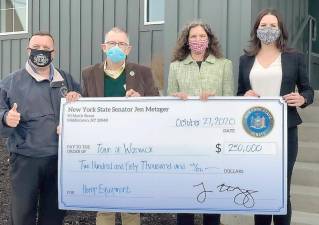 Senator Metzger presenting $250,000 in state funding to the Town of Warwick to purchase hemp trimming and testing equipment to rent to farmers, reducing the costs to local farms of diversifying into this high-value commodity. Left to right: Assemblyman Karl Brabenec, Warwick Town Supervisor Michael Sweeton, Senator Jen Metzger and Orange County IDA CEO Laurie Villasuso. Provided photo.