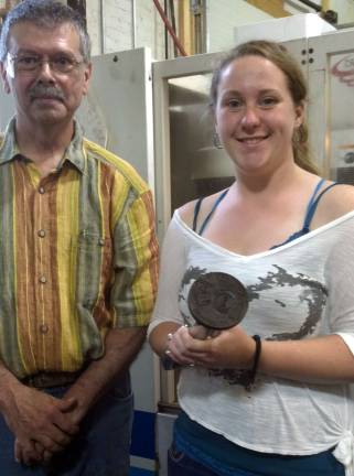 S.S. Seward artist creates winning design Cortnie Plocharzcyk, a student at S.S. Seward High School and BOCES Art & Design Academy, created the winning design in the Gillinder Glass Store's second annual ìDesign a Sun Catcherî contest. She is pictured here holding the mold of her sun catcher design. Standing next to her is Charlie Gillinder, sixth generation owner of Gillinder Glass in Port Jervis.