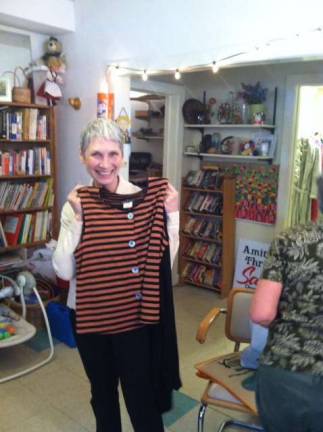 Amity Thrift Shoppe sells gently used treasures Diane Arcieri displays one of the many outfits for sale at the Amity Thrift Shoppe..