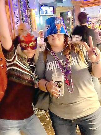 Girls just like to have fun: Mardi Gras volunteers Monica Dorfman and Jenna Price enjoying the Mardi Gras Jam and After Party at Village Billiards.