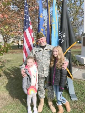 You called us heroes VFW Post 1708 Commander Ray Quattrini poses in front of the flag stand with his granddaughters, Samara and McKenna, who also led the crowd on hand in reciting the Pledge of Allegiance.