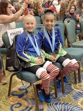 The Level 5 gymnasts Olivia Herlihy and Carla Zuluaga from the Orange County Sports Club.